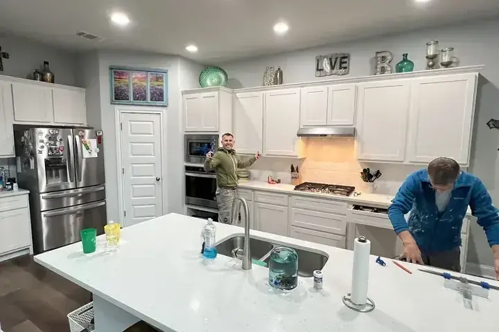 Crew restoring a kitchen after a supply hose leak
