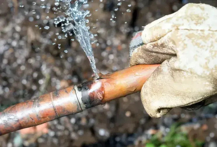 Water spraying from a split copper supply pipe